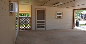 Storage in carport of frame house located at 1005 Houston St., Cotulla, TX